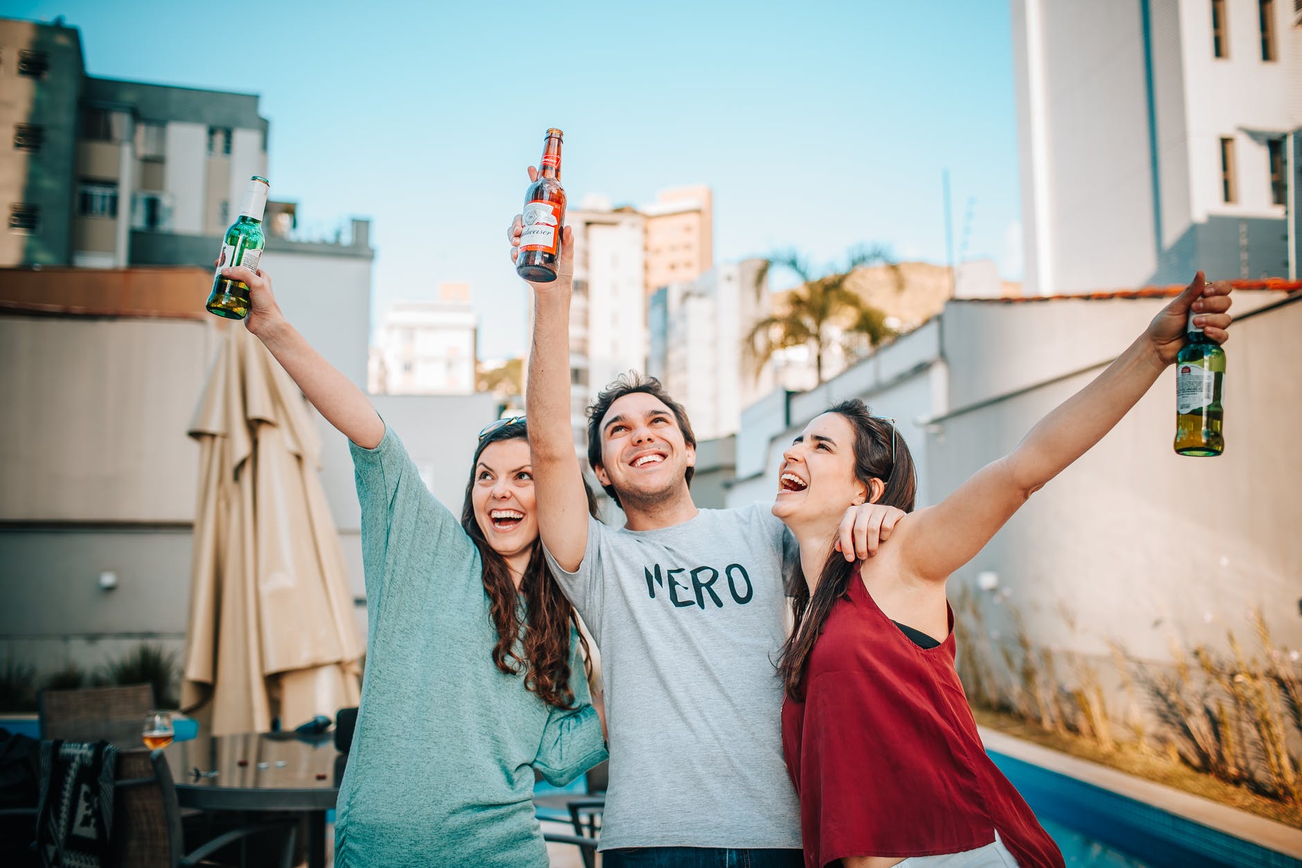 friends holding bottles of beer